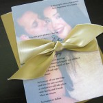 A traditional, gold custom wedding announcement with a photo of the couple.