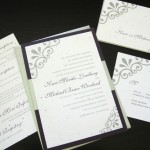 A modern, plum and silver custom wedding invitation set with inserts, reply postcard and wedding program.