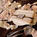 A modern, traditional custom wedding napkin holder displayed on dinner table for each guest.
