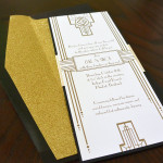 A Great Gatsby inspired custom, Art Deco, black and gold wedding invitation set.
