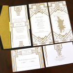 A Great Gatsby inspired custom, Art Deco, black and gold wedding invitation set with insert and reply postcard.