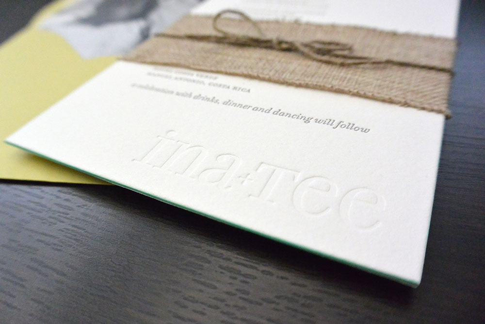 A close up of a modern, letterpress, custom wedding invitation set for a Costa Rica destination wedding with a photo of the couple as the envelope liner.