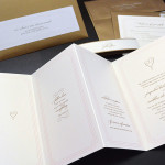 A modern, traditional custom 4 panel accordion fold wedding invitation set with reply card and envelope.