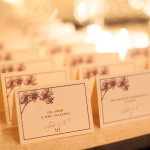 A modern, contemporary, orchid inspired custom wedding place cards displayed on table for guests.