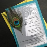 A custom peacock feather inspired 70th birthday party invitation.