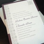 A modern, custom plum and silver wedding invitation set.