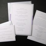 A minimalist, purple and silver custom wedding invitation set with insert and reply card.